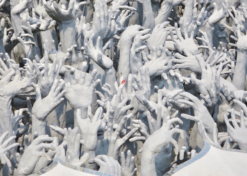 Wat Rong Khun White Temple In Chiang Rai – hundreds of hands from hell