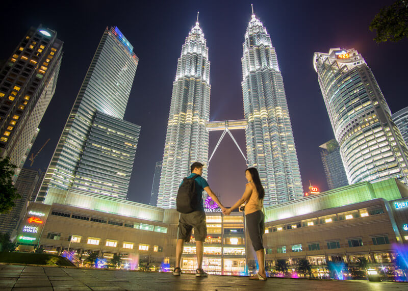 living as a nomad - couple petronas towers at night